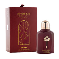 Armaf Club De Nuit Private Key burgundy fragrance bottle with gold key emblem next to maroon box with gold geometric design