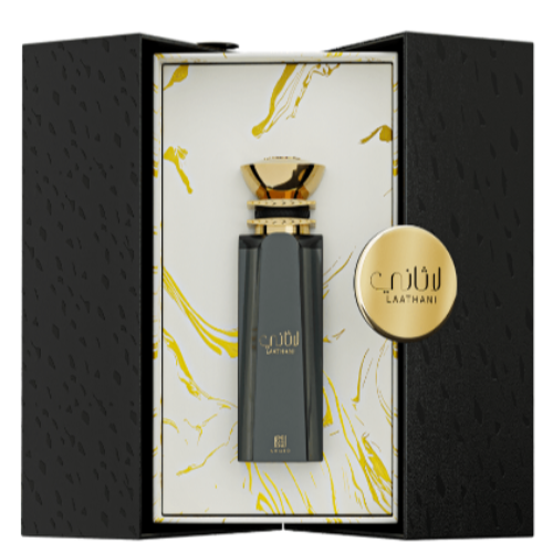 Ahmed Al Maghribi Laathani perfume bottle in black glass with gold cap, displayed in open black box with gold coin.