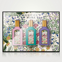 Gucci Flora Gorgeous mini fragrance set with three bottles on floral background front view