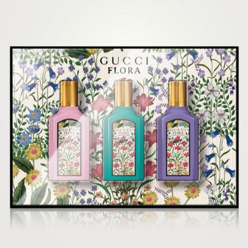 Gucci Flora Gorgeous mini fragrance set with three bottles on floral background front view