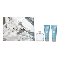 Azzaro Chrome gift set with clear fragrance bottle and two blue tubes on white fabric background