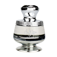 Ahmed Al Maghribi Hirfah Eau De Parfum bottle with chrome cap, cream band, and black stripe on pedestal base
