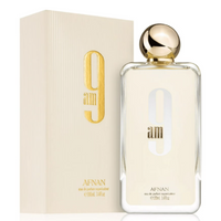 Afnan 9 Am eau de parfum bottle with gold cap next to cream colored box