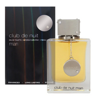 Armaf Club De Nuit man fragrance bottle with yellow liquid next to dark box packaging with silver medallion cap