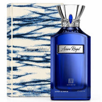 Azure Royal blue perfume bottle with silver cap next to cream and navy patterned box