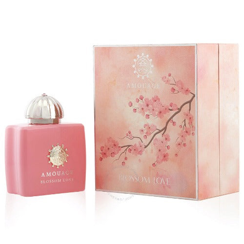 Amouage Blossom Love pink perfume bottle with silver dome cap next to matching box with floral artwork