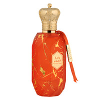 Red and gold marbled perfume bottle with ornate crown-shaped cap and ribbon bow