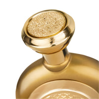 Gold perfume bottle with textured cap and rounded body design