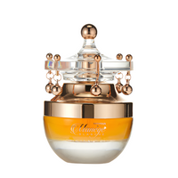 Al Haramain Manege Blanche fragrance bottle with rose gold crown top and frosted glass base