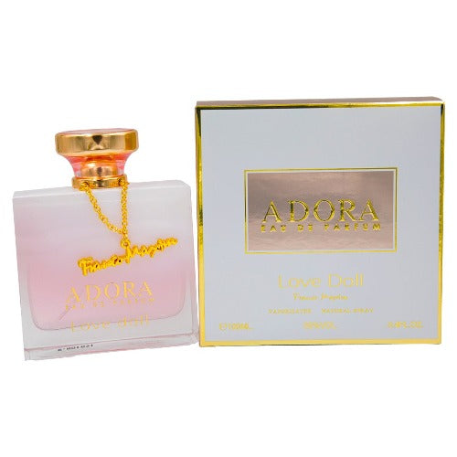 Adora Love Doll Eau De Parfum bottle with gold cap and pink liquid next to retail box with gold trim.