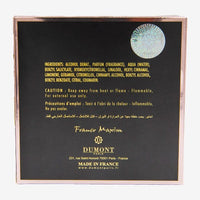 Dumont perfume box back panel showing ingredients, caution text, and brand details in gold lettering on black background.