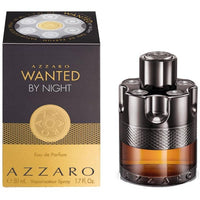 Azzaro Wanted By Night perfume bottle and box with gold accents on black background