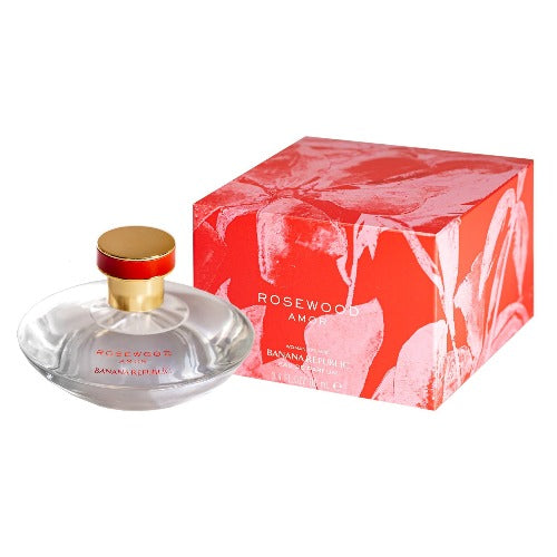 Rosewood Amor perfume bottle with gold cap next to red patterned gift box