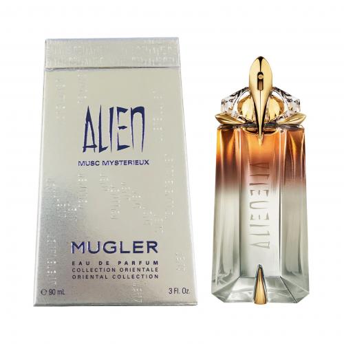 Alien Musc Mysterieux perfume bottle and box, gradient amber to clear glass with gold accents