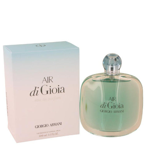 Air di Gioia perfume bottle with green liquid next to gradient pink and white box