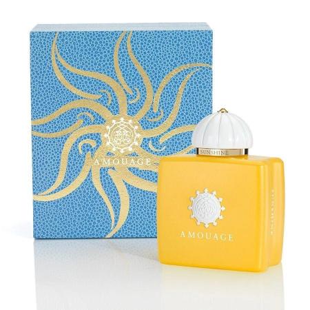 Amouage Sunshine Woman perfume bottle in yellow with blue patterned box featuring gold sun design.