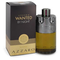 Azzaro Wanted By Night perfume bottle with black cap next to black and gold box packaging