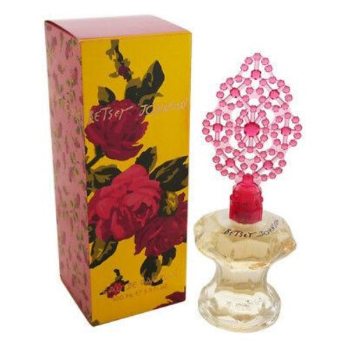 Betsey Johnson eau de parfum bottle with pink crystal stopper next to yellow and red rose printed box