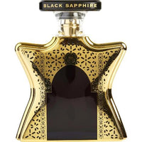 Bond No. 9 Dubai Black Sapphire perfume bottle with gold geometric patterned case and black center panel