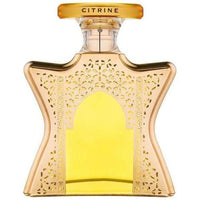 Bond No. 9 Dubai Citrine eau de parfum bottle with golden filigree design and yellow liquid center