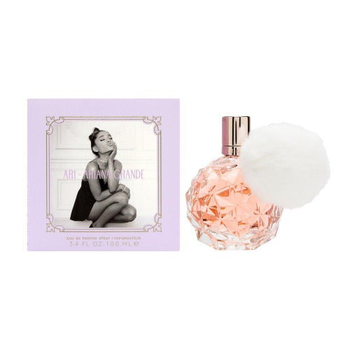 Ariana Grande Ari fragrance box in lavender with black and white portrait, paired with crystal-cut peach perfume bottle and white atomizer.