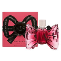 Bonbon Eau De Parfum bottle with pink bow-shaped design next to matching pink and black gift box