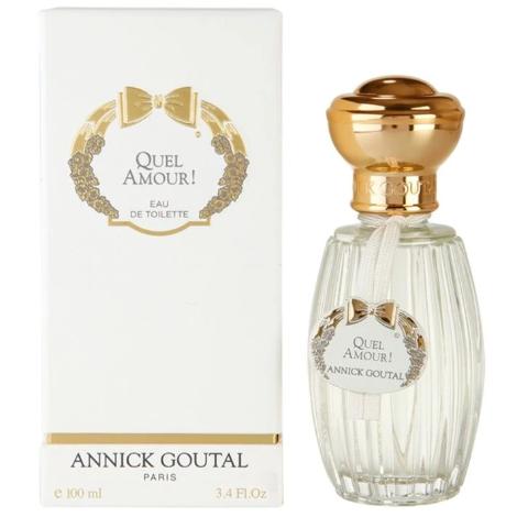 Quel Amour fragrance bottle with gold cap next to white box with gold bow design