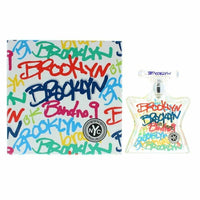 Bond No. 9 Brooklyn perfume bottle next to colorful graffiti-style box packaging in white, red, blue, and yellow.