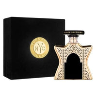 Bond No. 9 Black Sapphire perfume bottle with gold-speckled design next to black packaging box