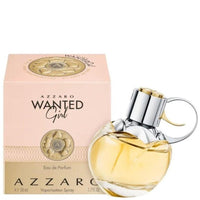 Azzaro Wanted Girl perfume bottle next to pink packaging with gold emblem detail