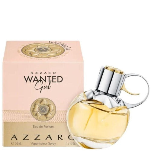 Azzaro Wanted Girl perfume bottle next to pink packaging with gold emblem detail