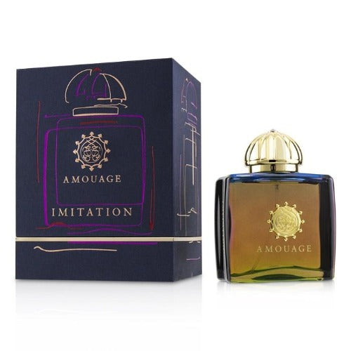 Amouage Imitation perfume bottle with gold dome cap next to dark purple box packaging