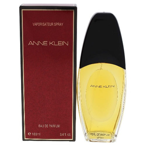 Anne Klein Eau De Parfum bottle with yellow liquid and black cap next to burgundy box